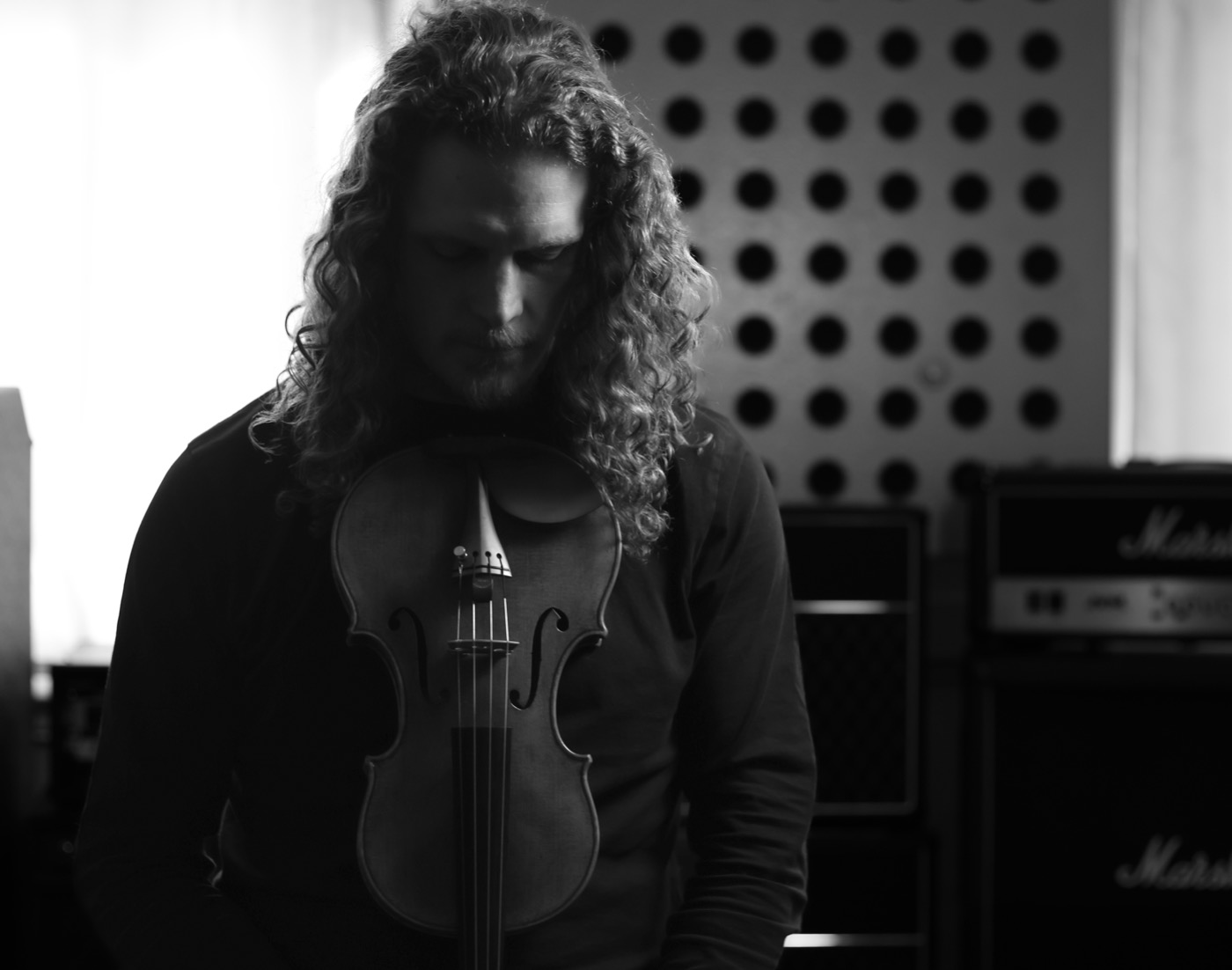 Rob holding his violin, black and white